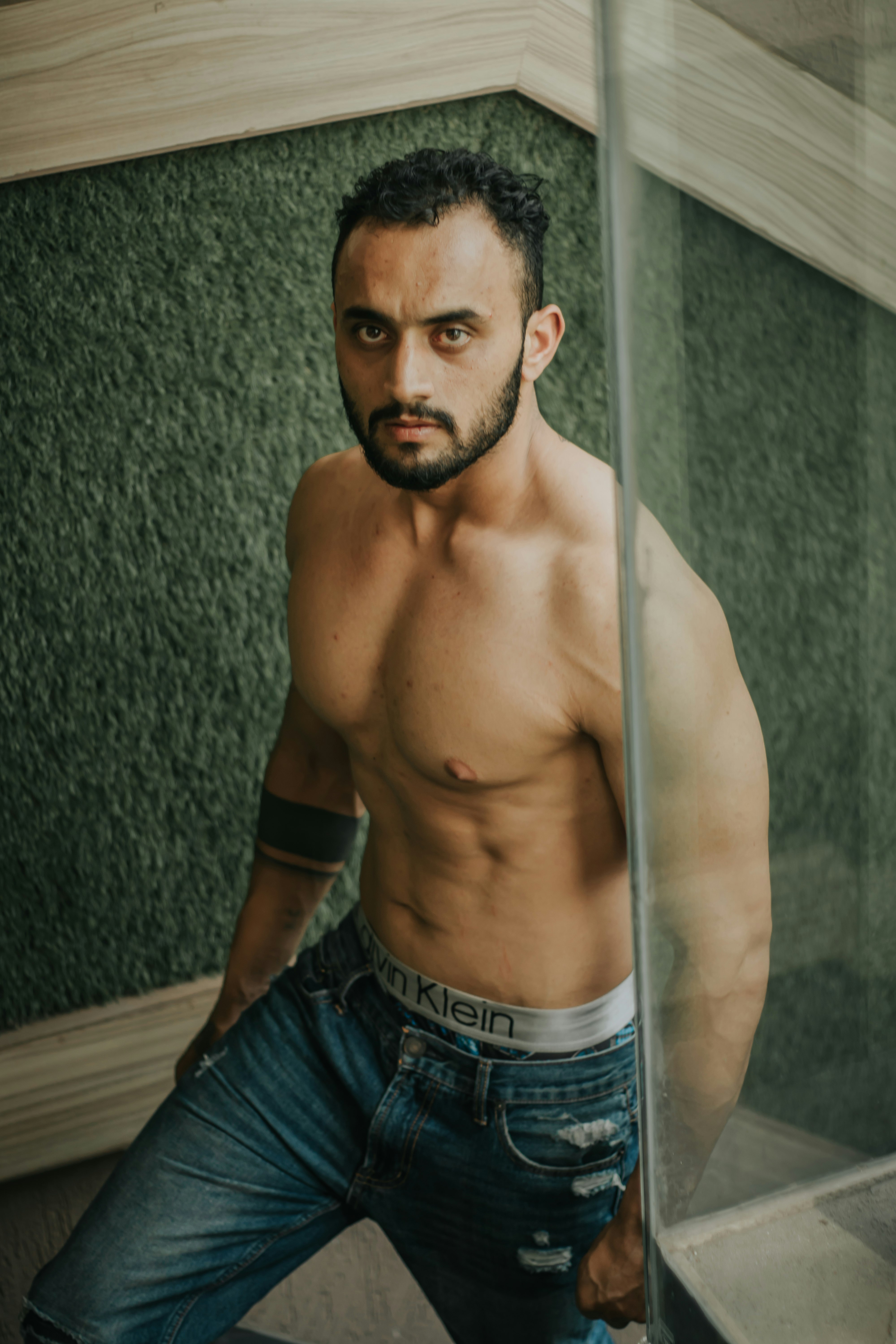 topless man in blue denim jeans